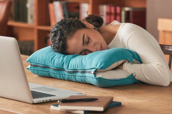 A 2-in-1 pillow that lets you sleep on your bed or at your desk!