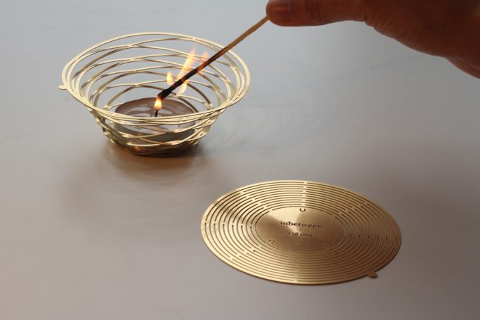 This pop up candle holder serenades as a coaster when not in use