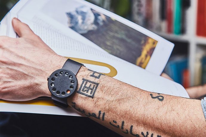 A hands free wooden watch that uses twelve little circles to tell the time!