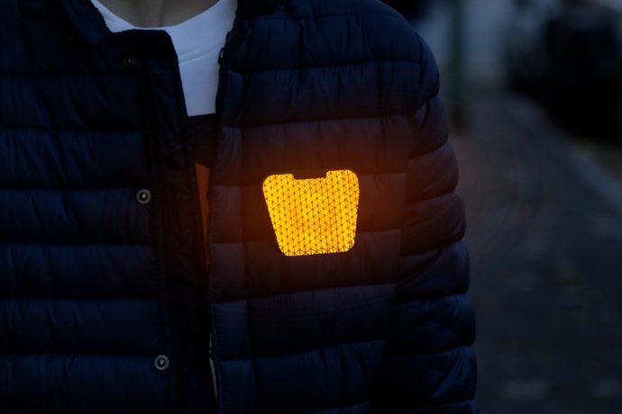 FLECTR’s reflective clip-on instantly makes pedestrians and cyclists visible in low-light settings