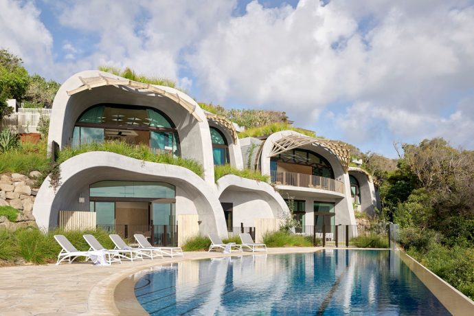 Organic concrete curves give an unconventional vibe to this sustainable luxury home
