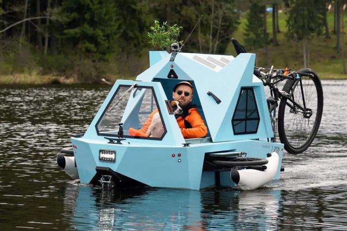 This electric tiny camper is a houseboat and trike designed to travel on land and water!