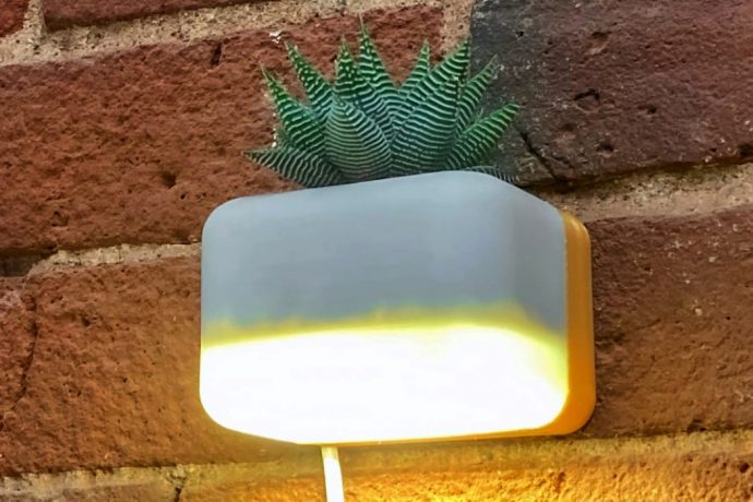 This wall-mounted succulent planter with a built-in lamp quite literally fills your space with warmth!