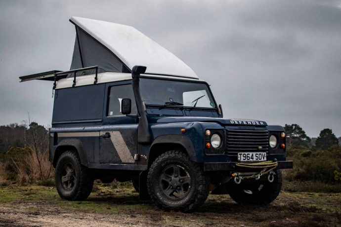 This Land Rover Defender camper’s pop-up roof unveils a lavish wooden cabin