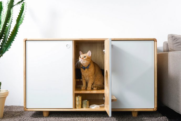 This cat kennel doubles as a cat tower and storage area with enough room for two indoor litter boxes!
