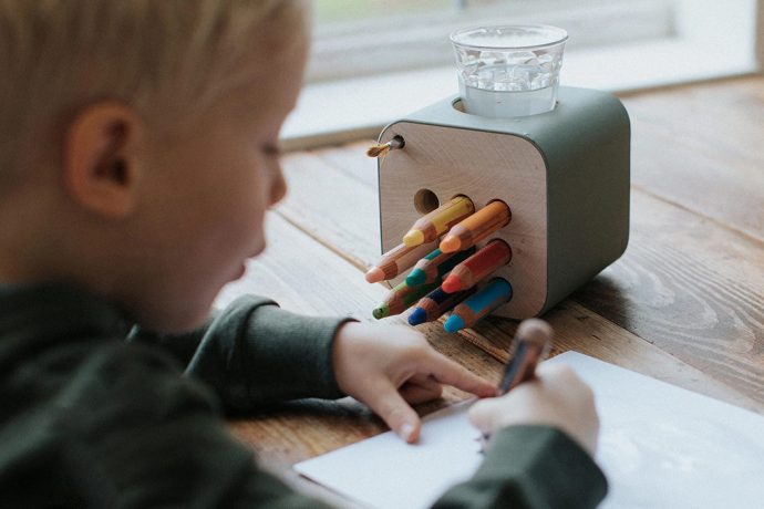 This intuitive wooden pen holder solves cleanup woes on messy art days and is designed to last a lifetime!
