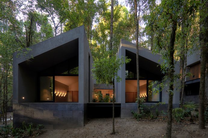 These volcanic stone cabins merge with the pre-existing trees to minimize the home’s footprint!