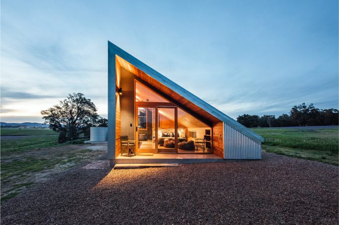 This 40sqm sustainable tiny home built using repurposed materials features a 30-degree solar-paneled roof!