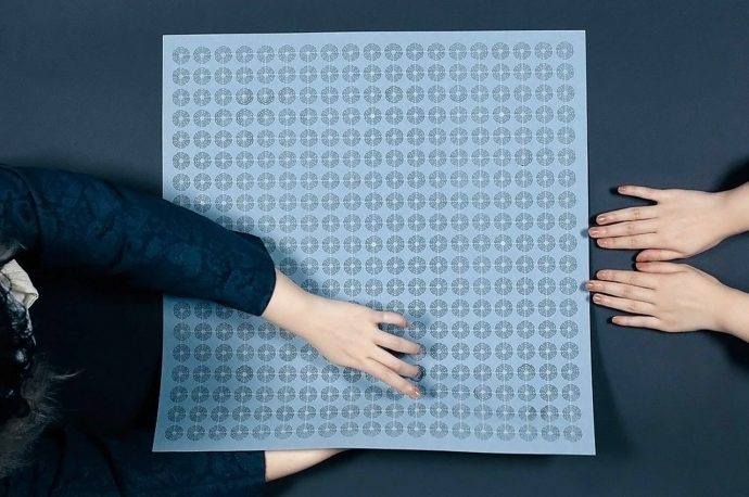 The Go board gets a portable and inclusive revision with this paper-based game design!