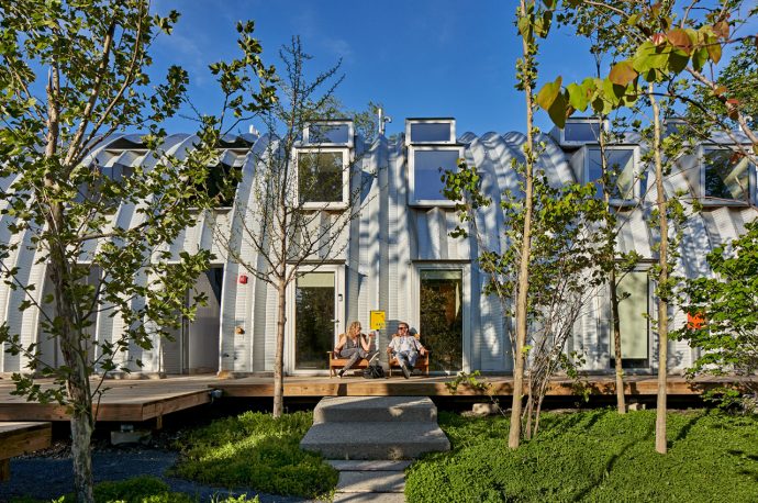 This prefabricated steel residence is built from a single Quonset hut to find community through modularity