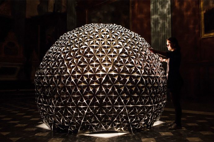 This interactive lotus-shaped art installation moves in response to light!