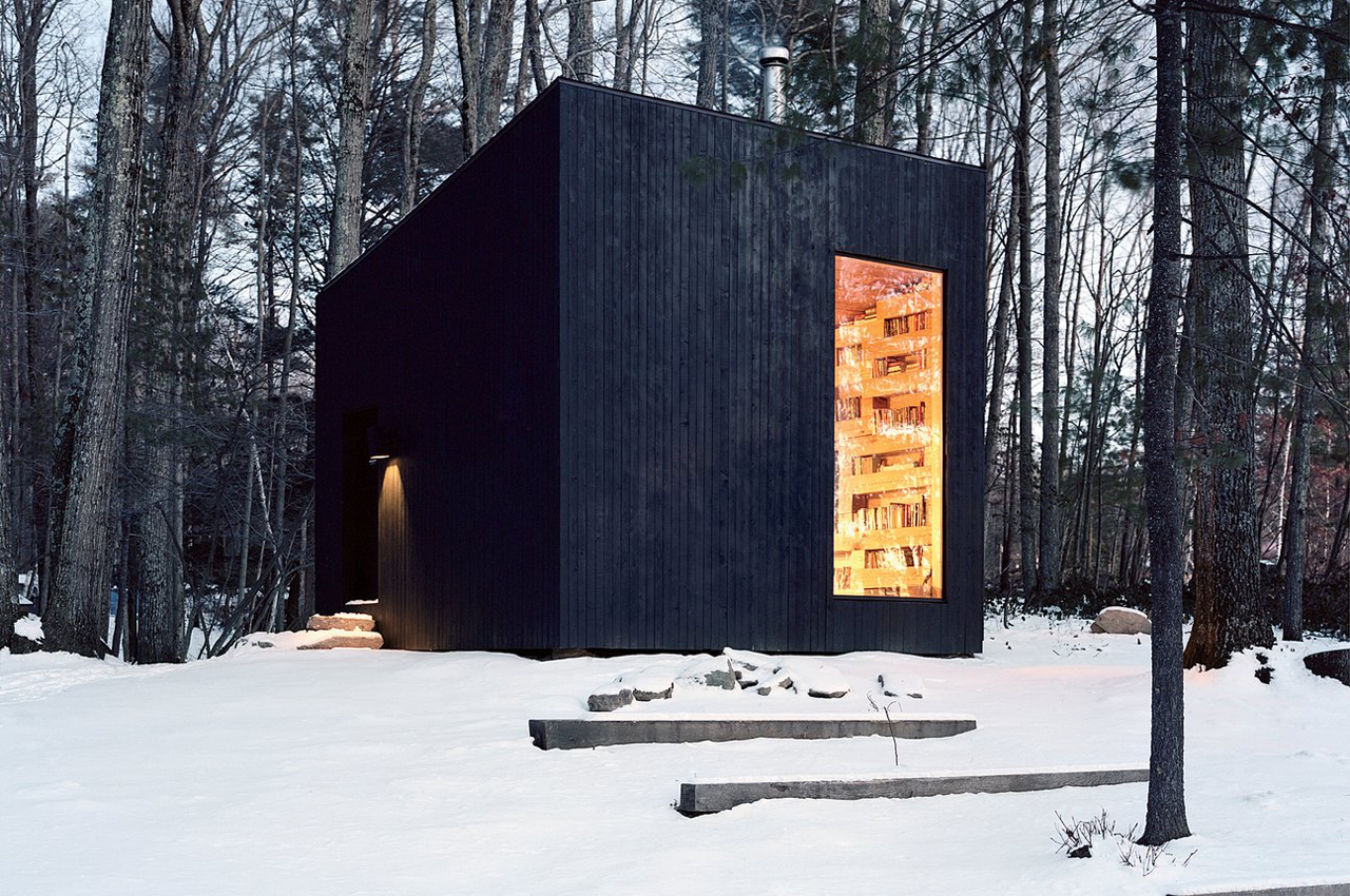 This tiny black cabin is built from felled oak trees acquired from a home’s construction waste!