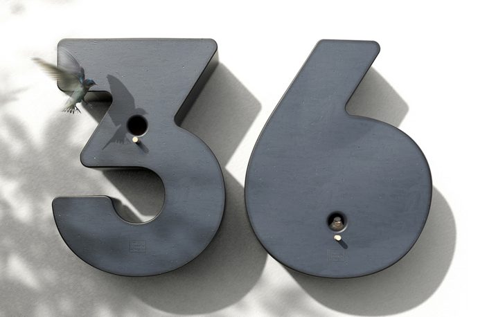 Birdhouses hide in these ingenious home address signs to encourage avian-urban biodiversity!