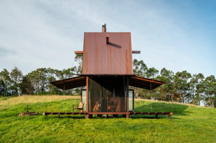 This tiny home designed for off-grid living features movable copper-clad awnings for natural ventilation!