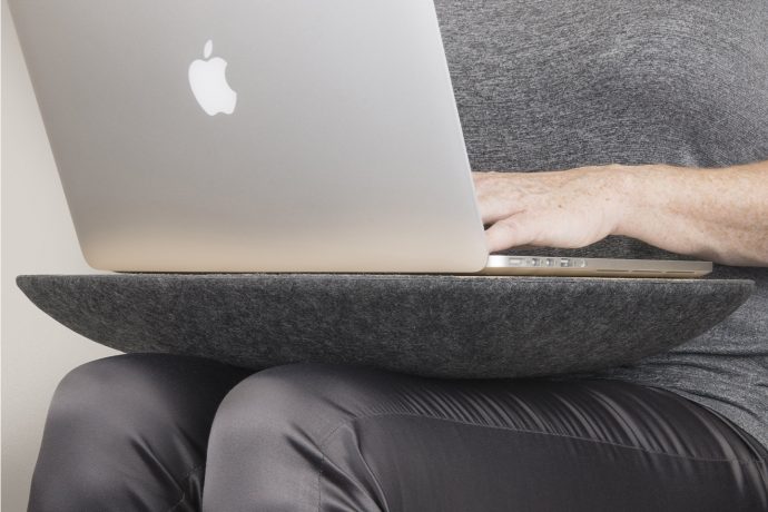 This laptop desk is cushioned, has storage space & makes working from couch more ergonomic!