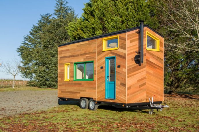 This tiny home on wheels uses colourful windows to create a fun space for a young family