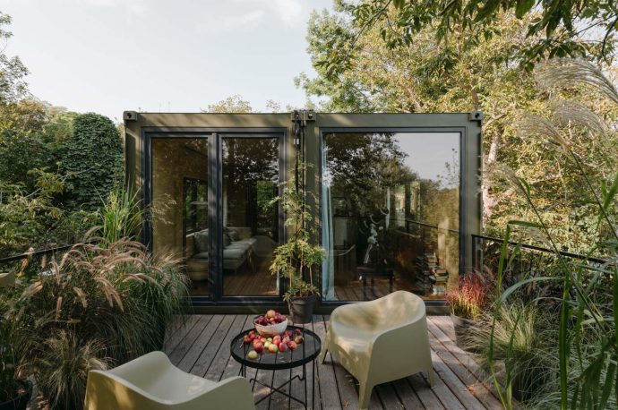 This mobile tiny home comprised of two disused shipping containers features a spacious terrace!