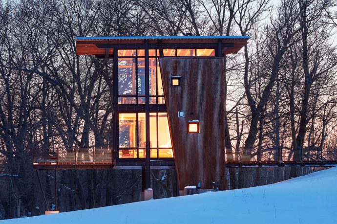 This half-glass, half-steel cabin is designed with naturally insulating material to brace all elements