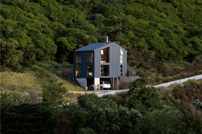This compact home finds harmony with New Zealand’s landscape through off-grid features and a small footprint