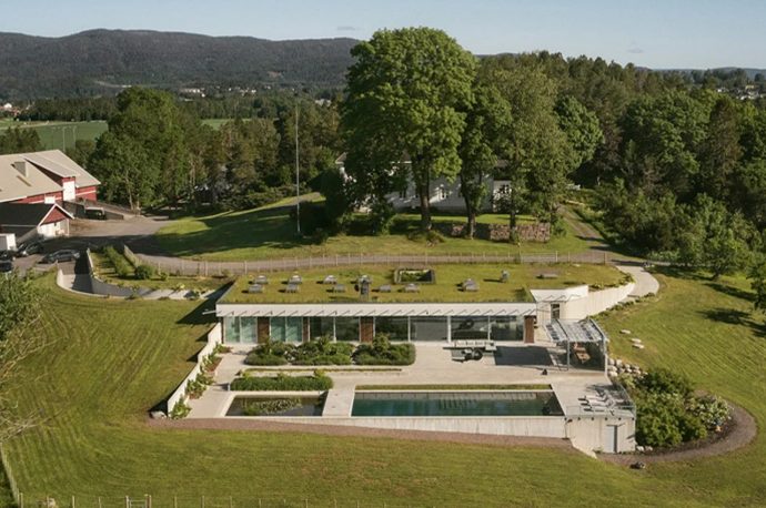A green roof helps this villa in Norway to blend in with the surrounding countryside