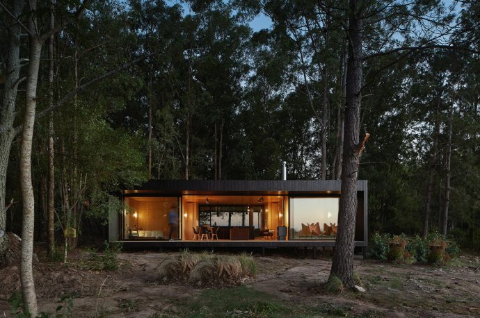 This prefabricated modern cabin is clad in black and hidden in plain sight on Colonia’s coast