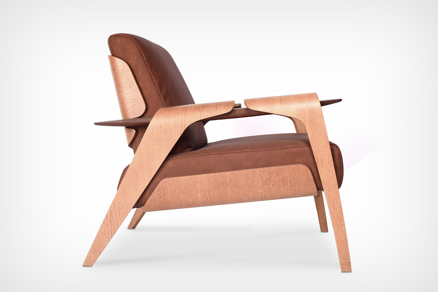 #With its bent wood veneer and leather design, the Fly Armchair feels like a modern take on the Eames Lounge Chair