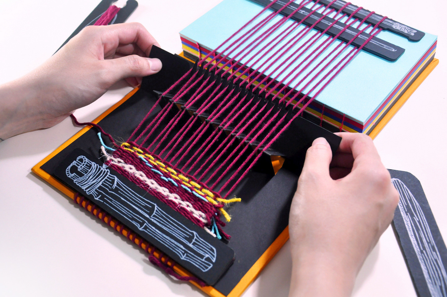 #This book opens up into a miniature fully-functional handloom machine that lets you weave cloth!