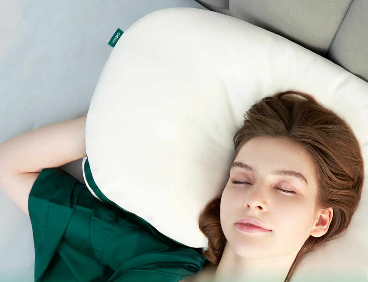 Multi-layer modular supportive pillow also comes with a pocket to tuck your hands into while sleeping
