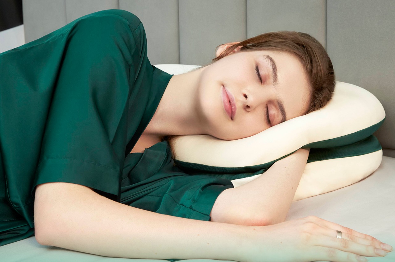 Multi-layer modular supportive pillow also comes with a pocket to tuck your hands into while sleeping