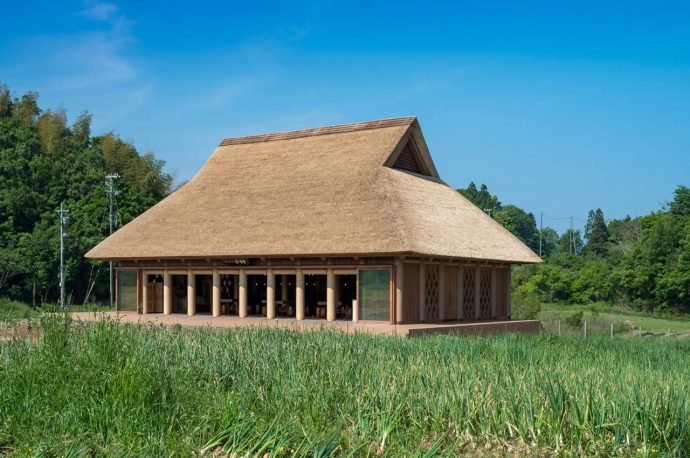 This restaurant on a Japanese island features a thatched roof and large cardboard tubes