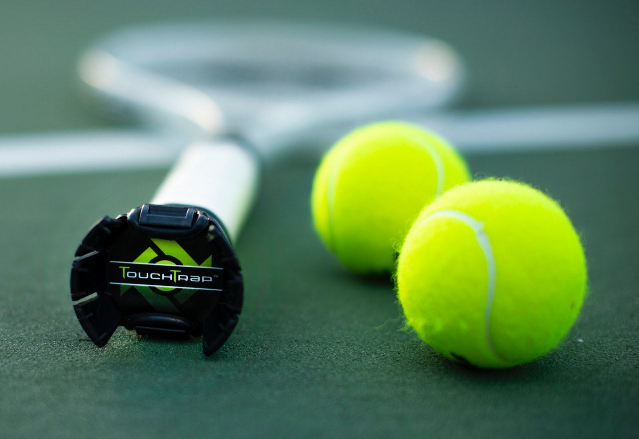 Ingenious tennis racquet grip attachment will pick up tennis balls off the ground for you