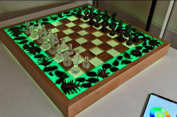 This beautiful handmade chessboard makes it looks like you’re playing on water