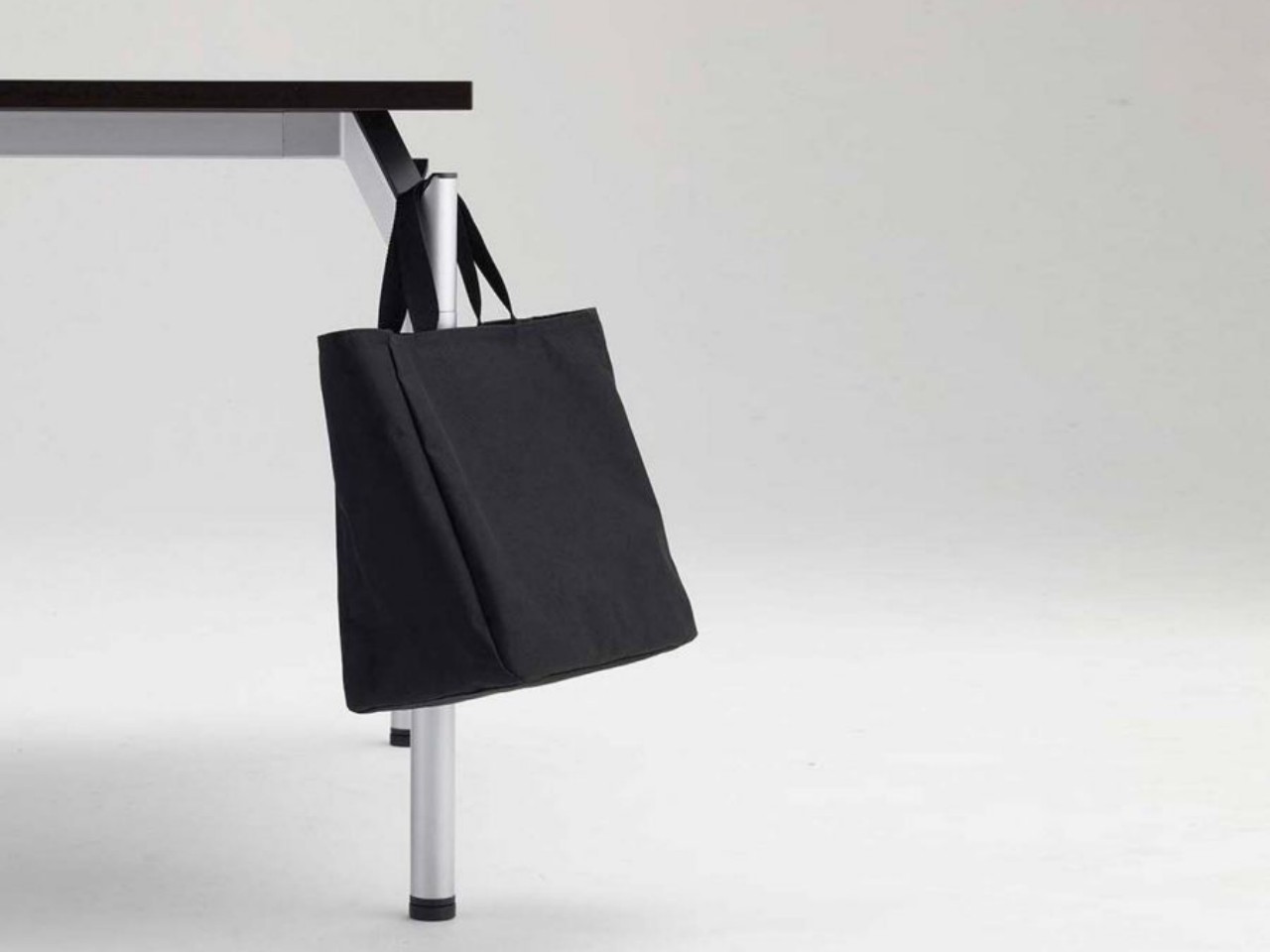 This simple table has an equally simple solution for hanging your bags