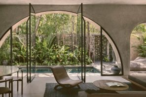 This rustic concrete home in Tulum is nestled within a tropical garden