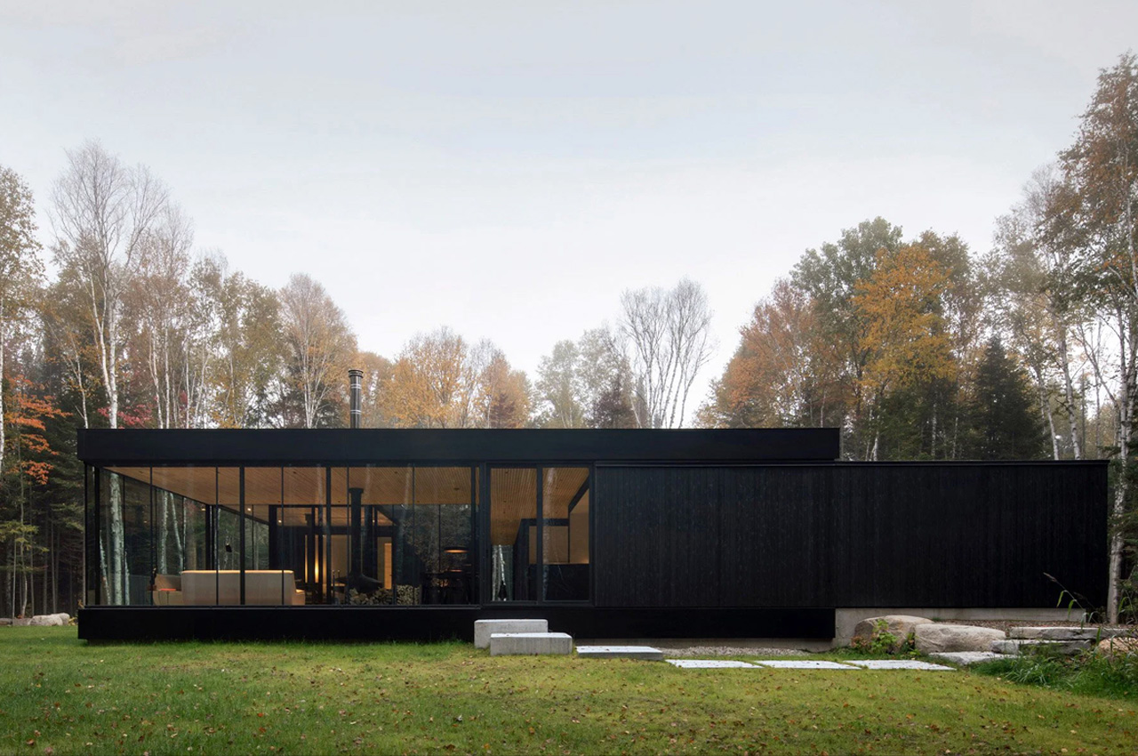 #This all-black glass home was designed to wrap around an apple tree