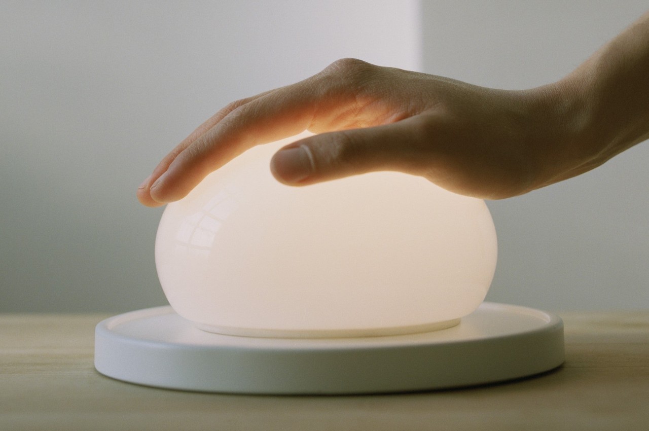 This delicate glass lamp invites you to touch and move it to actually use it