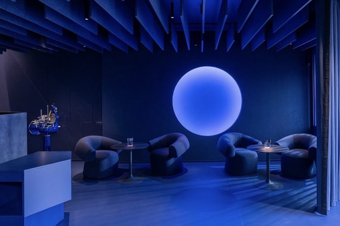 This two Michelin-star restaurant in Italy features a bar lounge immersed in blue and neon orange light