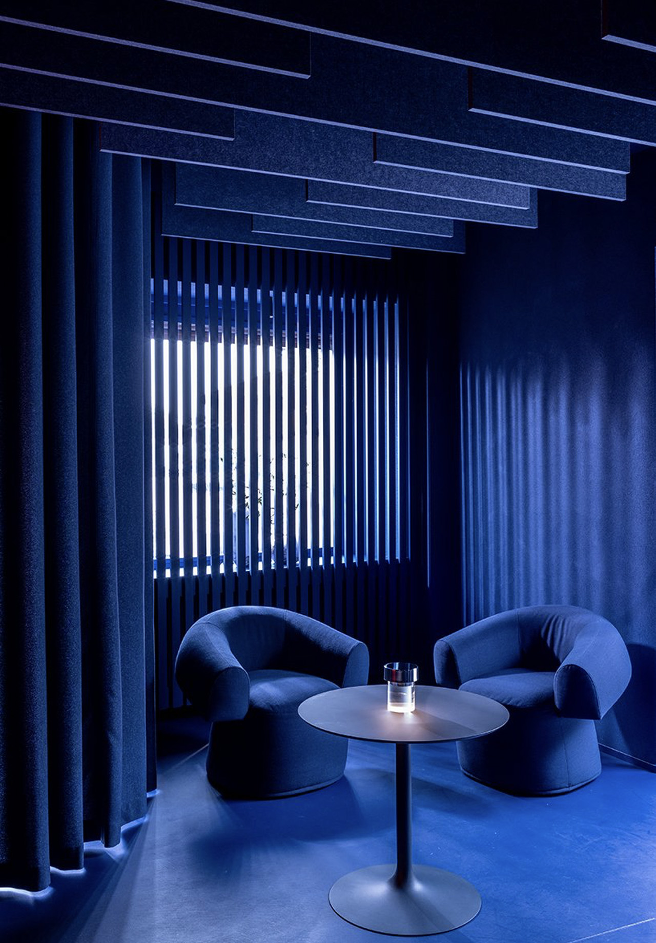 This two Michelin-star restaurant in Italy features a bar lounge immersed in blue and neon orange light