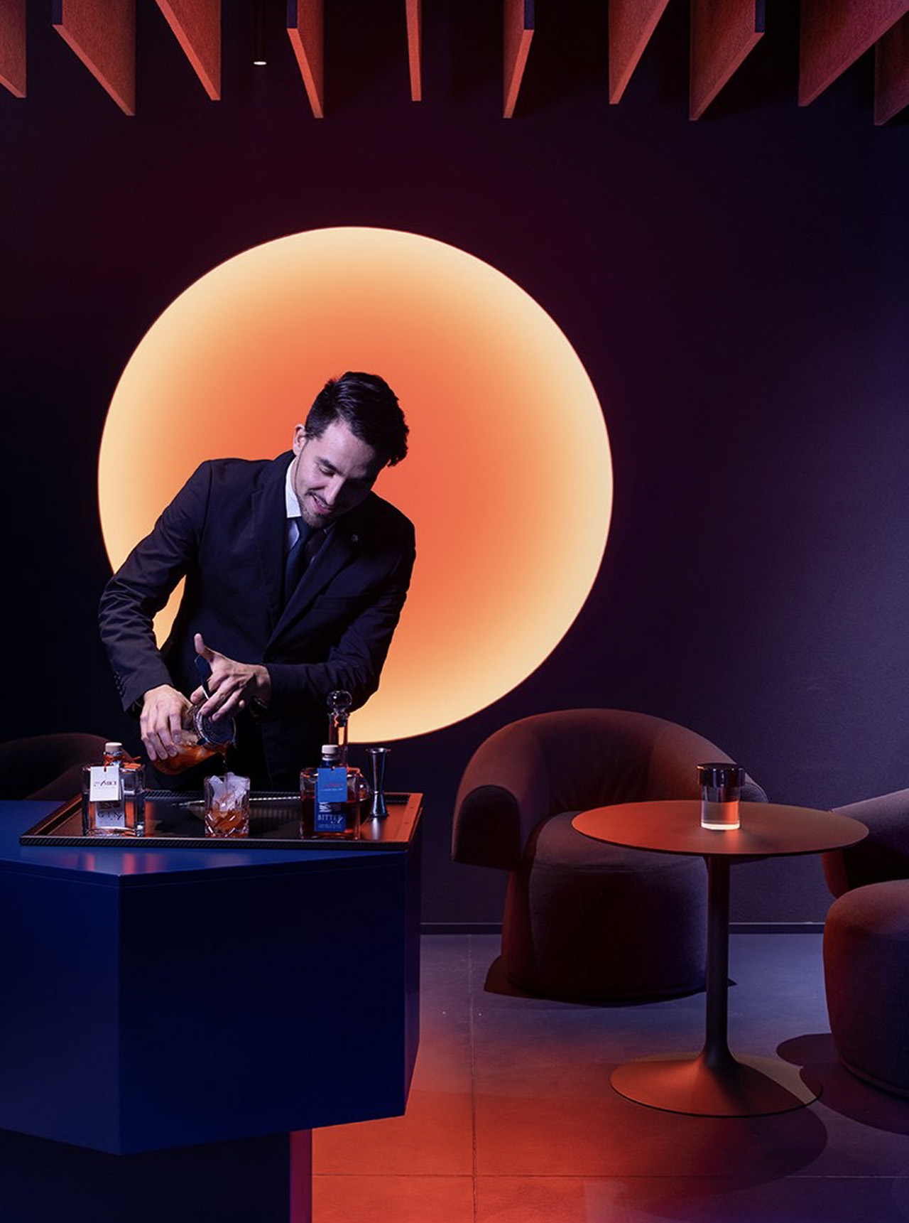 This two Michelin-star restaurant in Italy features a bar lounge immersed in blue and neon orange light