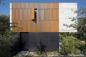 The Wood Slatted House is a sturdy concrete home in Tel Aviv with foldable wooden shutters