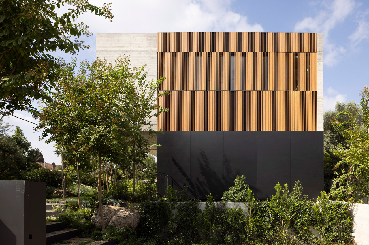 The Wood Slatted House is a sturdy concrete home in Tel Aviv with foldable wooden shutters