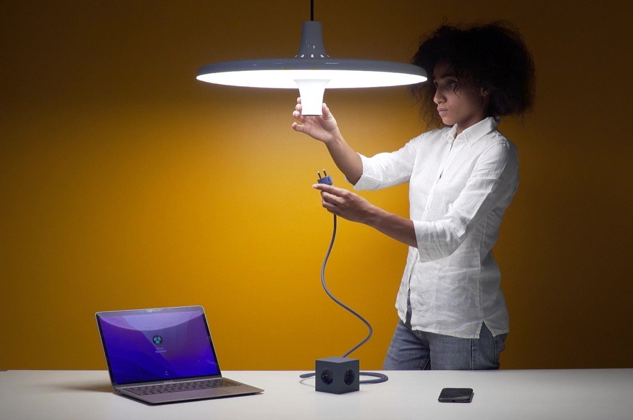 #UFO-like pendant lamp hides a power socket that turns any table into a workstation