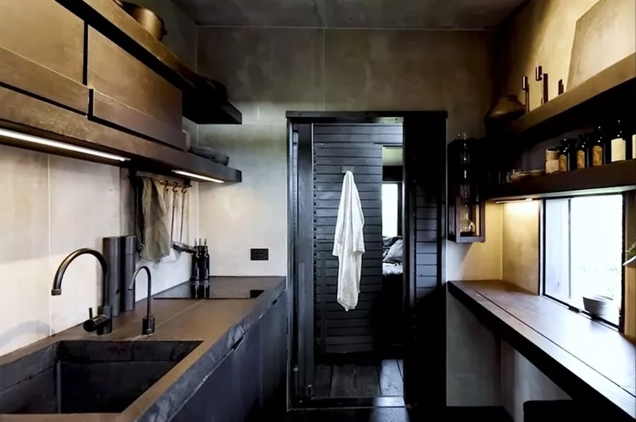 This charred wood self-built tiny home executes all the dont’s of designing for a small space