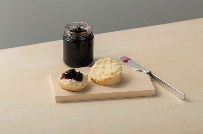 This minimal Japanese folding knife can be hooked onto the edge of a plate