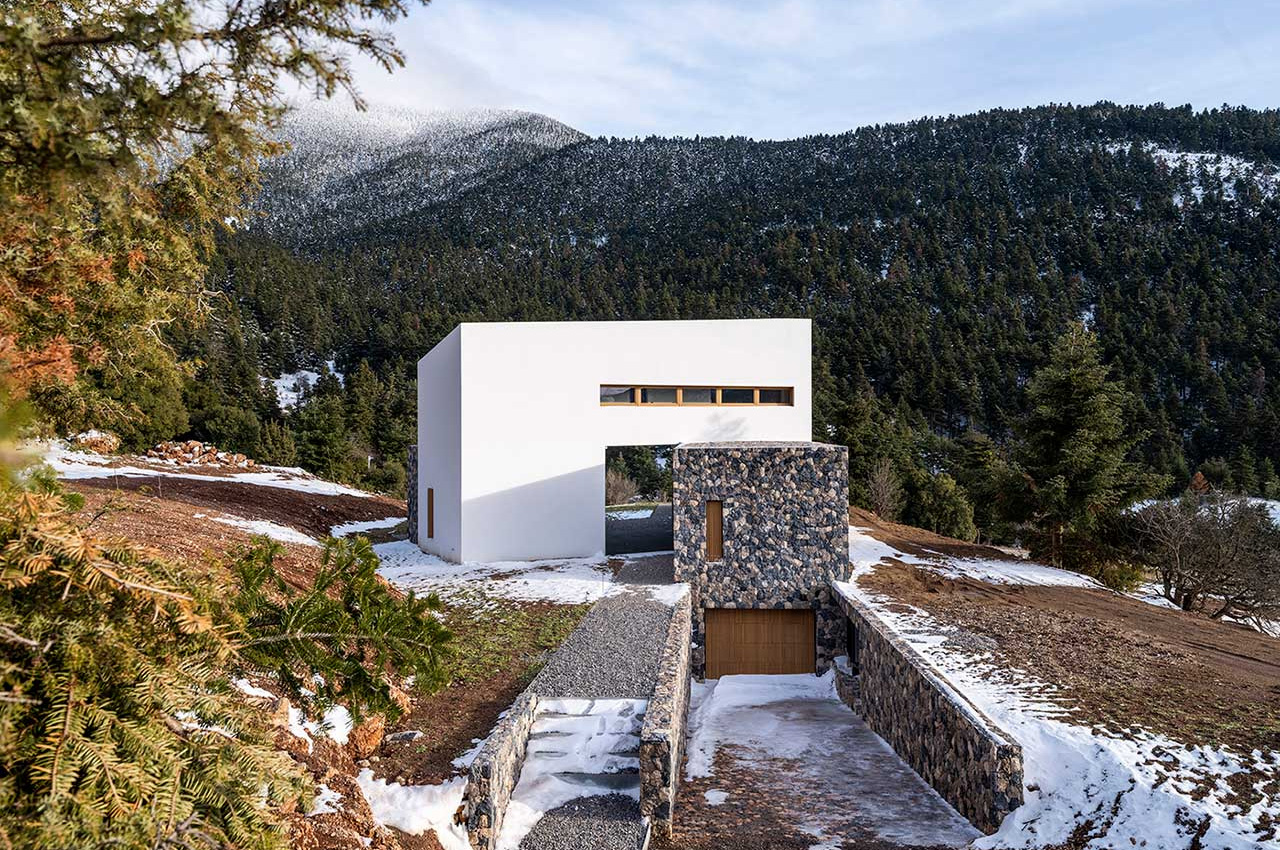 Three angled volumes make up this cozy + minimal home in the Greek mountains