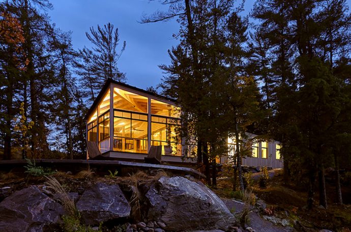 This idyllic wooden cabin overlooks a lake and the natural landscape of Ontario