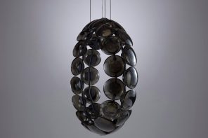 Unique other-worldly lighting fixture is made up of dark textured glass discs