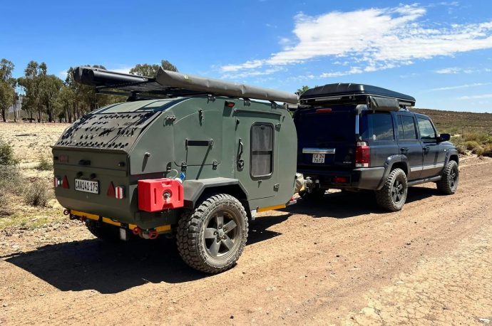 Red Gecko TDX teardrop trailer hauls behind a small SUV to the world of untamed beauty