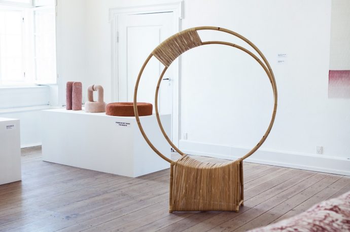 This wooden chair uses a geometric trick to draw you into its open embrace