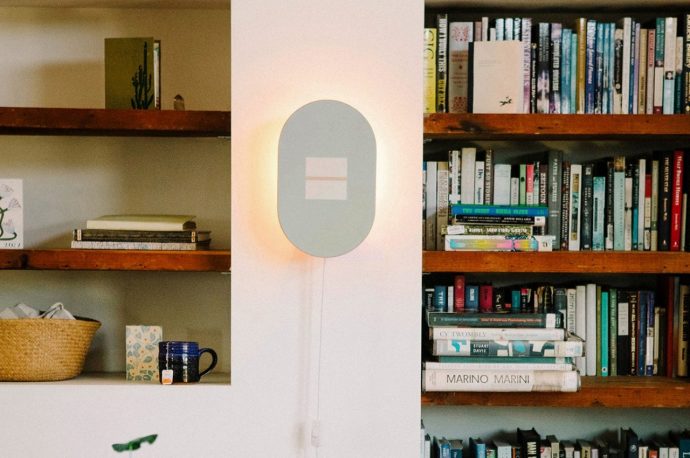 Upcycled skateboard factory rejects transform into warm wall lighting